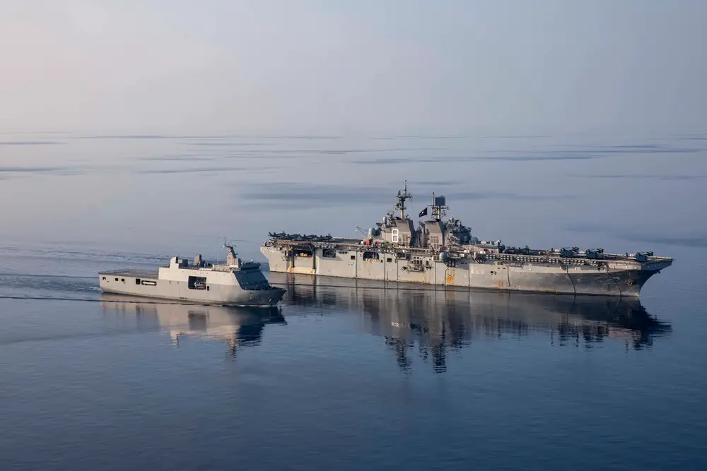 Amphibious assault ship USS Makin Island (LHD 8), right, transits alongside Philippine navy ship BRP Tarlac (FF 601), during a replenishment-at-sea rehearsal for Balikatan 23, April 15, 2023 in the South China Sea. 