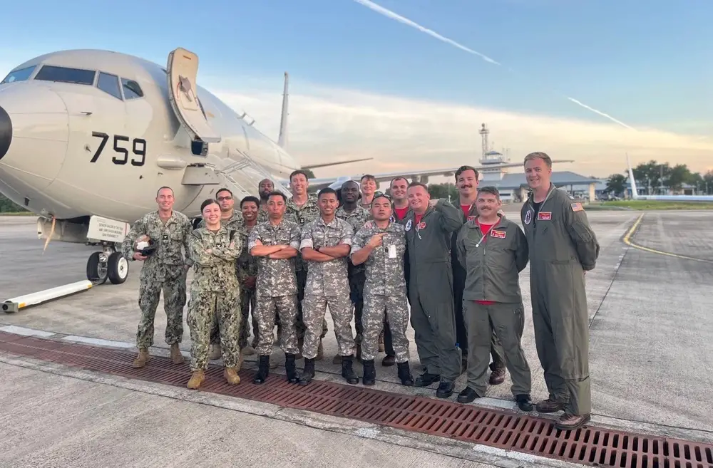 Members of Patrol Squadron (VP) 16 and the Royal Brunei Armed Forces (RBAF) in front of a static display of a U.S. Navy P-8A Poseidon during the 62nd anniversary of RBAF Day, which celebrates the founding of Brunei’s land, air and sea forces. VP-16 conducts maritime patrol and reconnaissance as part of a rotational deployment to the U.S. 7th Fleet area of operations. (U.S. Navy Photo by Lt. j.g. Ernest Waggy)