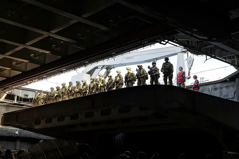 Australian Army soldiers are lifted onto the flight deck of HMAS Adelaide for Wet and Dry Environmental Rehearsal serial during Exercise Sea Explorer 23.