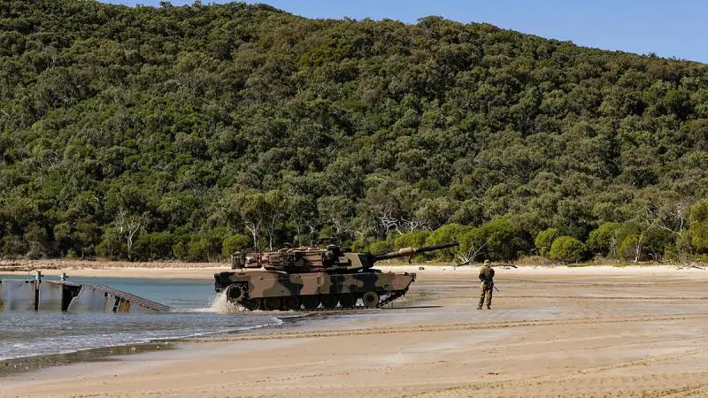 An M1A1 Abrams main battle tank leaves the Mexe-flote after being delivered to the beach head from HMAS Choules.