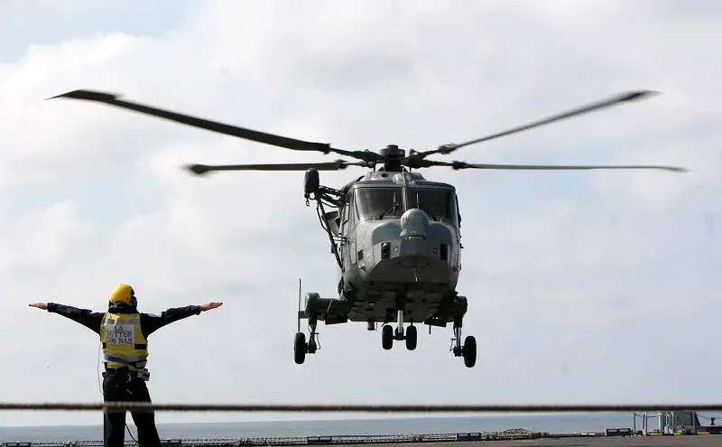 Leading Airman Michael Butter guides a Wildcat off the deck of RFA Mounts Bay