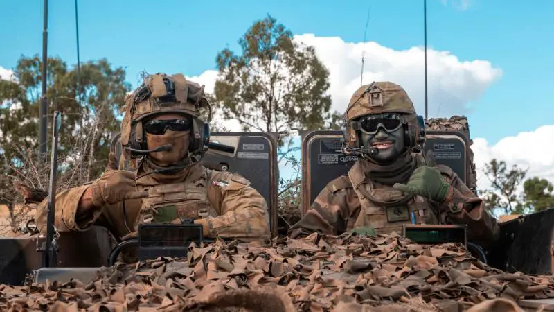 Australian Army Private Samuel Austen-Wilkins, left, and His Majesty;s Armed Forces of Tonga Lance Corporal Sione Atoa mounted in an Australian Army Boxer combat reconnaissance vehicle during Exercise Talisman Sabre. (Photo by  Corporal Nicole Dorrett)