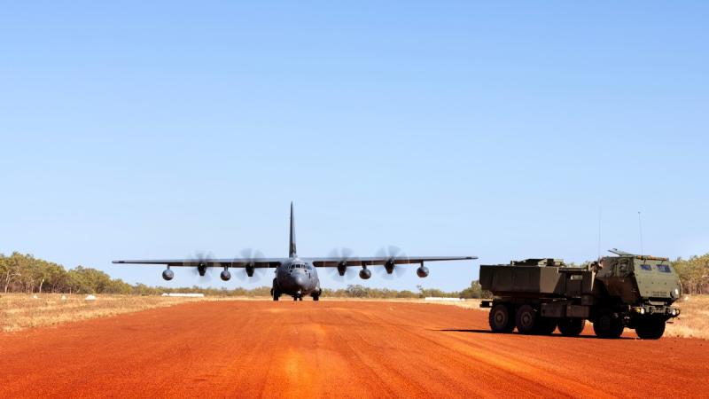 Personnel from the US Army wait to board a US Air Force MC-130J for HIMARS rapid infiltration at Williams Airfield, Shoalwater Bay Training Area, Queensland.