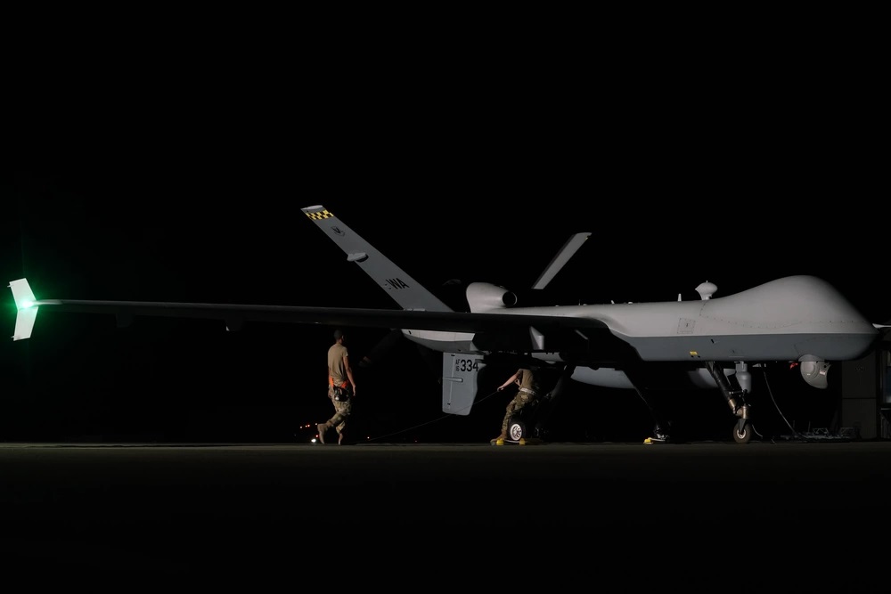 U.S. Air Force Airmen, assigned to the 432nd Aircraft Maintenance Squadron, perform post-flight checks on an MQ-9A Reaper on the flight line at Marine Corps Air-Ground Combat Center, Twentynine Palms, California, July 25, 2023. The remotely piloted aircraft was being used in Service Level Training Exercise (SLTE) 5-23, a Marine Corps exercise, and its participation is critical to increasing joint capabilities, proficiency and lethality. (U.S. Air Force photo by Senior Airman Ariel O’Shea)