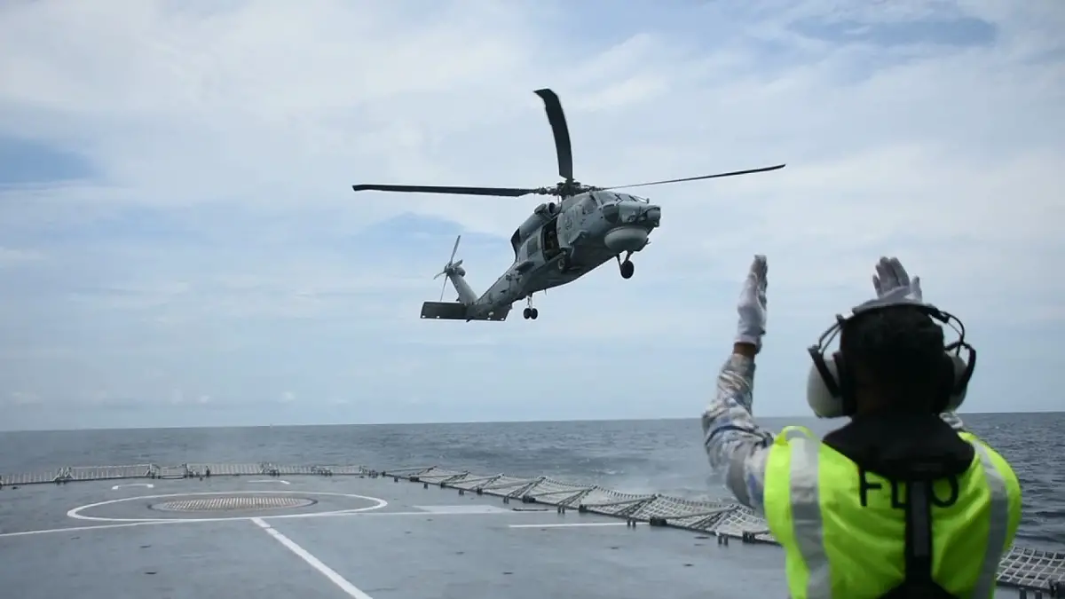 The Singapore S-70B naval helicopter conducted a cross-deck landing on the Malaysian navy ship KD Lekiu