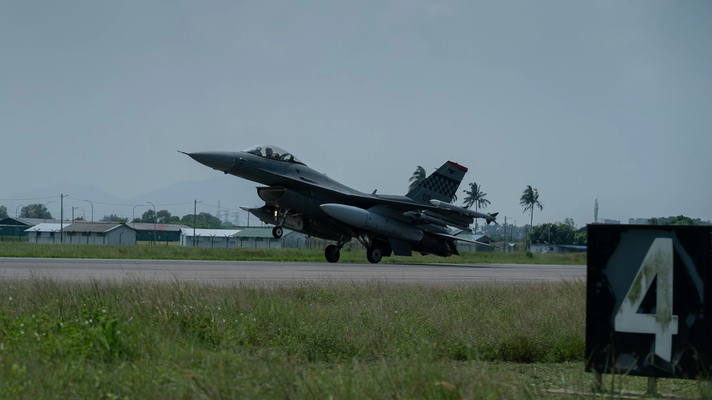 An F-16 Fighting Falcon from the 51st Fighter Wing, Osan Air Base, Republic of Korea, lands on a runway after completing a nine-ship formation during a photo exercise while conducting bilateral operations to ensure readiness during Cope Taufan 23 at Royal Malaysian Air Force P.U. Butterworth, Malaysia, Sept. 28, 2023.