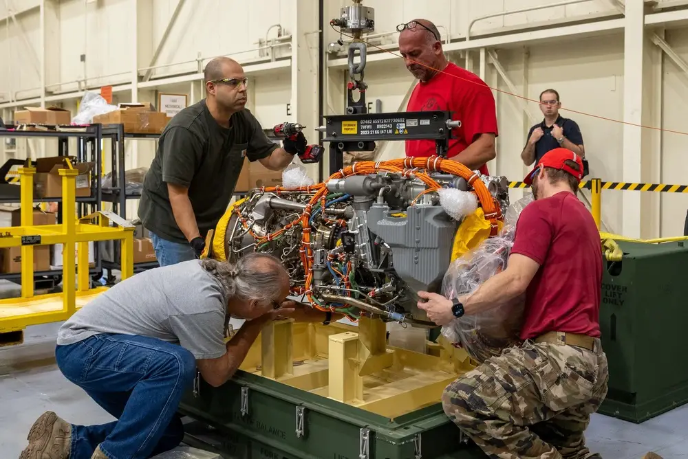 Sikorsky team members remove a recently delivered T901 engine from it shipping crate at the Sikorsky facility in West Palm Beach on Oct. 20.