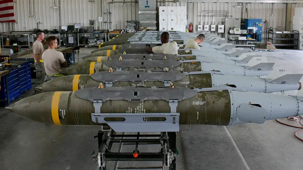 A dozen 2,000-pound bombs fitted with Joint Direct Attack Munition tail kits sit inside a warehouse at Al Udeid Air Base, Qatar