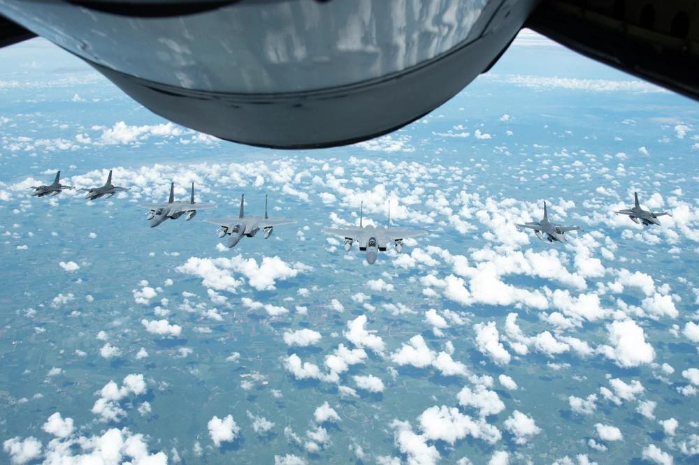 F-15 Eagles from the 142nd Wing, Portland, Oregon and F-16 Vipers from the Royal Thai Air Force fly in formation over Korat Air Base Royal Kingdom of Thailand during Enduring Partners 2023, Sept. 20, 2023.