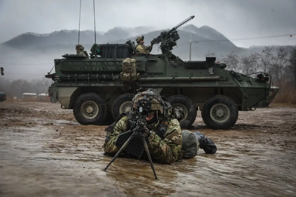 A squad automatic weapon (SAW) gunner assigned to 1st Battalion, 17th Infantry Regiment, 2nd Stryker Brigade Combat Team, 2nd Infantry Division pulls security outside of a M1126 Stryker Combat Vehicle during a squad training exercise on January 13, 2023 at Twin Bridges Training Area in South Korea during Korea Rotational Force 12.