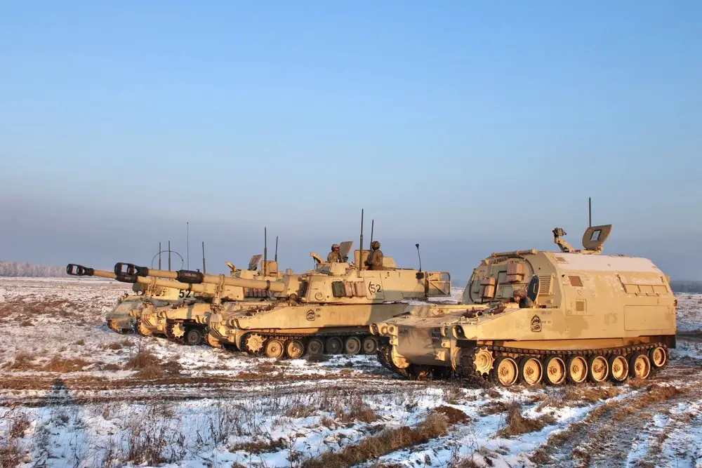 Iron Thunder! Armored field artillery tracks assigned to the Bravo Battery, 4th Battalion, 27th Field Artillery Regiment, 2nd Armored Brigade Combat Team, 1st Armored Division, stand aligned during the US-Polish MARS 23 LFX in Toruñ, Poland on December 1, 2023.