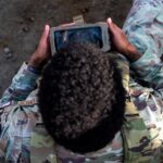 U.S. Air Force Senior Airman Sebastian Bryant, a security forces squadron defender, uses the Android Tactical Assault Kit (ATAK) system at an undisclosed location within the U.S. Central Command area of responsibility, Dec. 16, 2023. The ATAK provides defenders with improved communication and immediate situational awareness during base emergencies. (U.S. Air Force photo by Tech. Sgt. Sergio A. Gamboa)