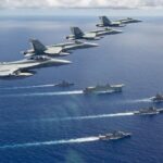 A formation from Air Force of three F/A-18A Hornets, and an EA-18G Growler from fly over a Navy task group of HMA Ships Canberra, Hobart, Stuart, Arunta and Sirius