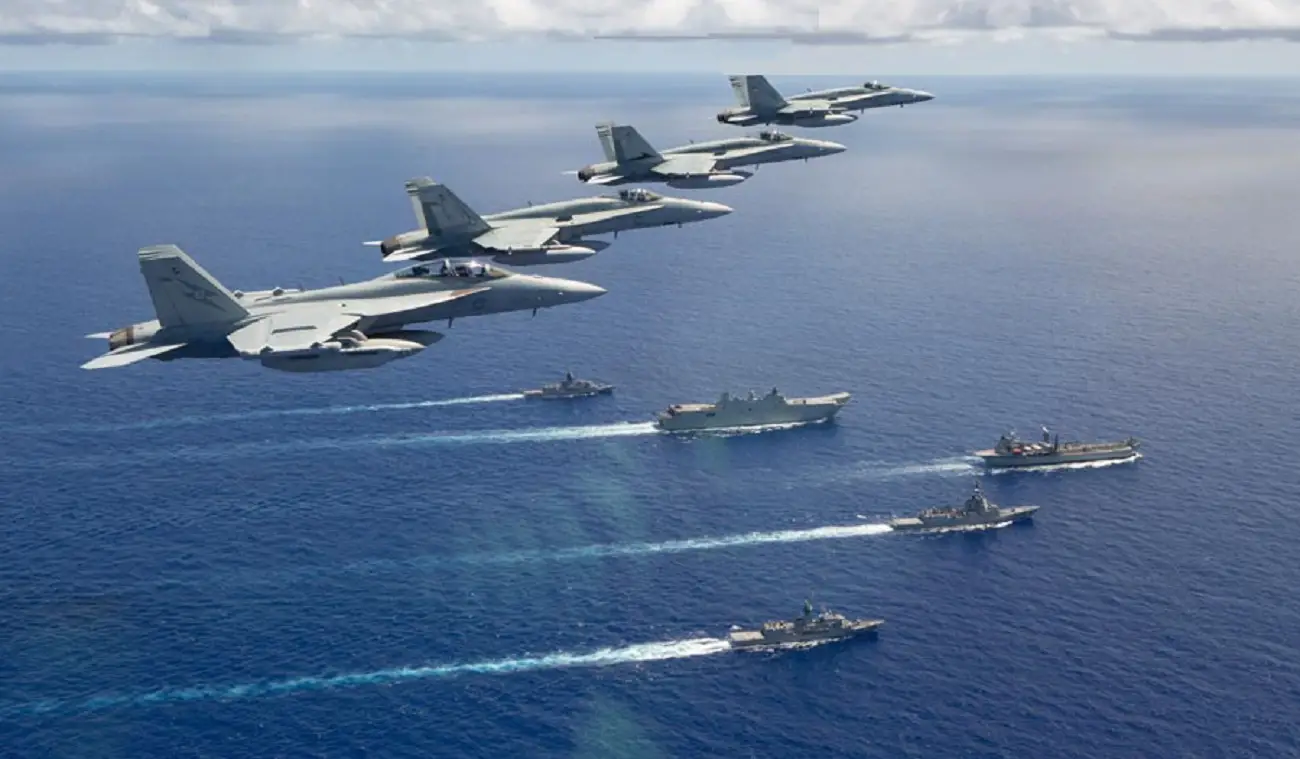 A formation from Air Force of three F/A-18A Hornets, and an EA-18G Growler from fly over a Navy task group of HMA Ships Canberra, Hobart, Stuart, Arunta and Sirius