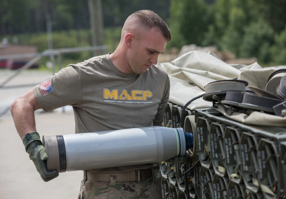 A U.S. Army Master Gunner Instructor, assigned to 3rd Squadron, 16th Calvary Regiment, removes a M829A4 sabot tank round out of thee canister to load into the loader hatch on a M1A2 SEP V2 Abrams Tank where to move at Ware Range, Fort Benning, GA., July 20, 2021. 
