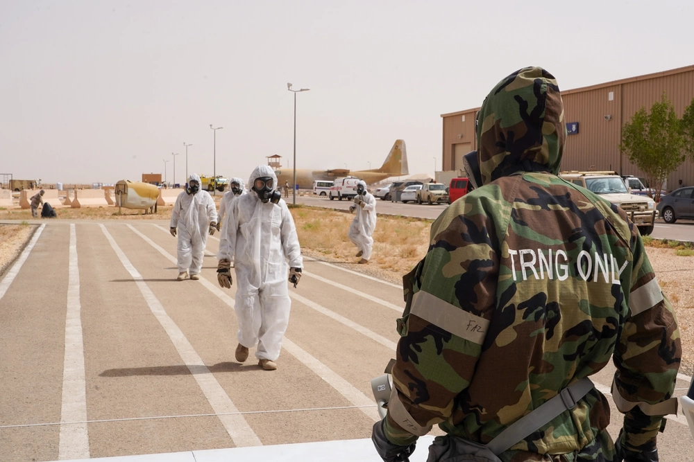 An Airman from the 378th Expeditionary Civil Engineer Squadron, Emergency Management (EM), waits for joint training partners from the Royal Saudi Air Force (RSAF) in a decontamination (DECON) training opportunity at Prince Sultan Air Base, Kingdom of Saudi Arabia, June 12 2023. EM Airmen worked with RSAF as part of a joint training opportunity, where EM Airmen removed simulated contaminants and illustrated DECON procedures to RSAF personnel. The training provided Airmen with vital hands-on experience, and an opportunity to work with their RSAF counterparts. (U.S. Air Force Photo by Tech. Sgt. Alexander Frank)
