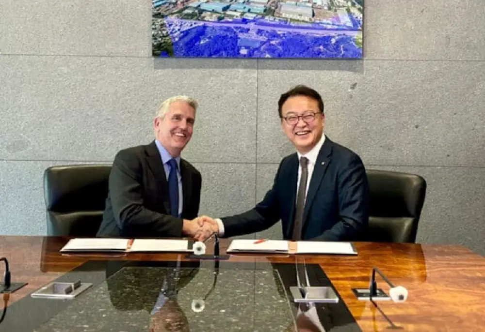Neal Misell chief executive for mission systems at Babcock (left) and Hanwha Ocean representative (right) sign contract for the weapon handling launch system.