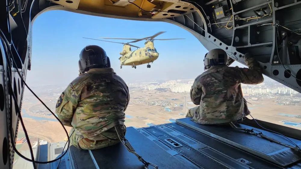 U.S. Army Sergeants Qadiyr Ajala and Dustin Spivey assigned to Bravo Company, 3rd General Support Aviation, 2nd Combat Aviation Battalion, 2nd Infantry Division, ROK-US Combined Division operate as crew chiefs for a U.S. Army CH-47 Chinook during an air assault training event as part of exercise Freedom Shield 24, in South Korea