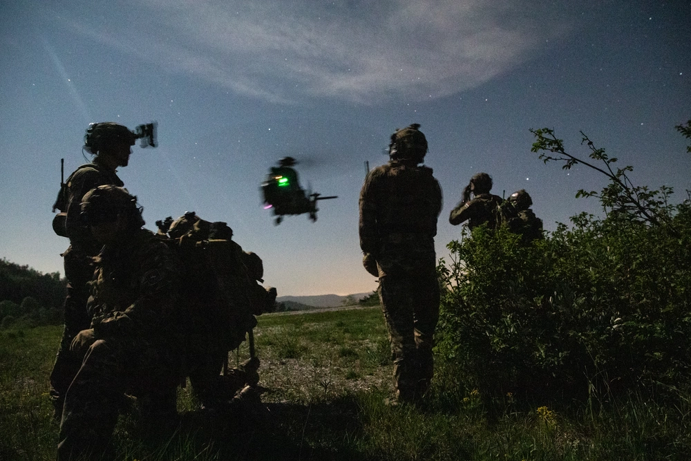 U.S.10th Special Forces Group Special Operations Forces (SOF) along with Slovenian and Croatian SOF prepare to load an arriving Cougar helicopter during joint terminal attack controller (JTAC) training near Pocek, Slovenia, May 12, 2022. 