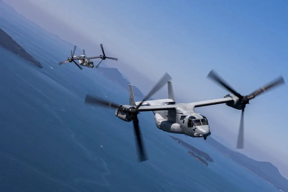 A U.S. Marine Corps MV-22 Osprey tiltrotor aircraft with Marine Medium Tiltrotor Squadron (VMM) 262, Marine Aircraft Group 36, 1st Marine Aircraft Wing, conducts a bilateral formation flight alongside a Japan Ground Self-Defense Force V-22 Osprey tiltrotor aircraft with 107th Squadron, Transport Aviation Group, 1st Helicopter Brigade, during the field training exercise portion of Resolute Dragon 23 off the coast of Kumamoto, Japan