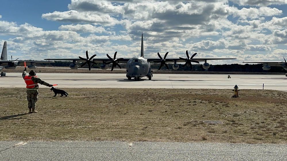 A U.S. Air Force maintainer marshals a HC-130J Combat King II search and rescue aircraft, assigned to the 106th Rescue Wing, as it leaves the flightline during Exercise Agile Rage 2024 on F.S. Gabreski Air National Guard Base in Westhampton Beach, N.Y., February 29, 2024.