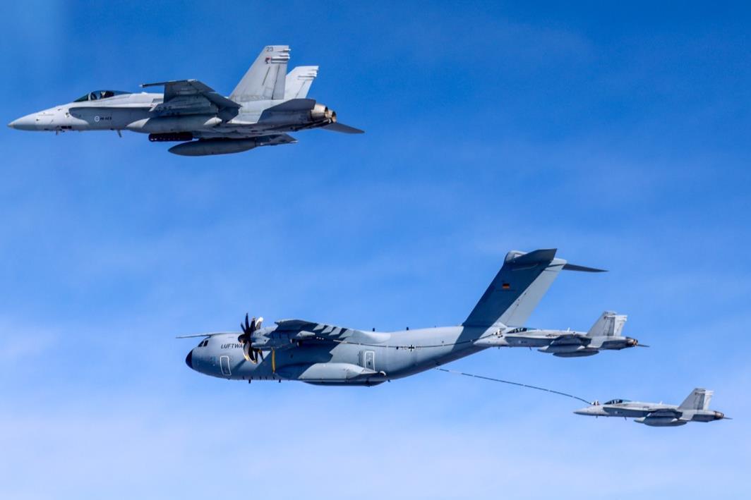 Finnish F/A-18 fighter jets with  receiving fuel from a German A400M tanker/transport aircraft during combined drills enhancing interoperability and skills of Allied pilots.