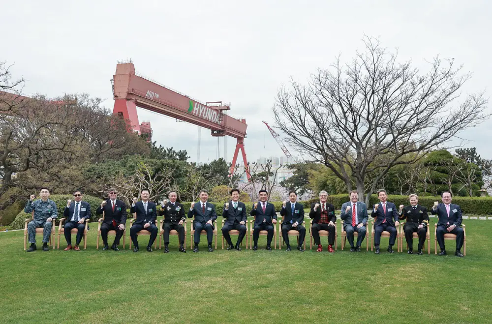 HD Hyundai Heavy Industries officials take a commemorative photo after the delivery signing ceremony of Shin Chae-ho at its Ulsan shipyard with guests from the Ministry of National Defense, the Defense Acquisition Program Administration and government officials from nine countries