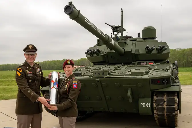 U.S. Army Capt. Rachel Ledbetter, company commander of the M10 Booker Test Detachment, 82nd Airborne Division, based out of Fort Liberty, N.C., receives a ceremonial shell casing during the M10 Booker Dedication Ceremony at Aberdeen Proving Ground, in Aberdeen, Md., April 18, 2024. In attendance from the command team of the first M10 Booker Company in the U.S. Army, were: Lt. Col. Jordan Martinelli, the battalion commander; 1st Sgt. Michael Cohn; and Master Sgt. Derry Giddings, the operations senior enlisted advisor. (U.S. Army photo by Christopher Kaufmann)