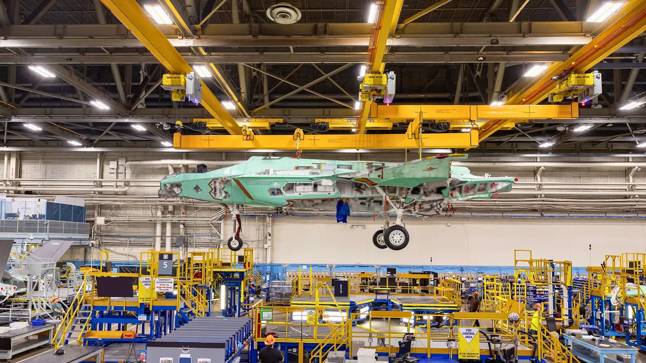 Poland’s first F-35, known as AZ-01, is lifted by an overhead crane from the Fort Worth factory’s electronic mate and alignment station, where its major components were joined together to form the structure of the jet. 