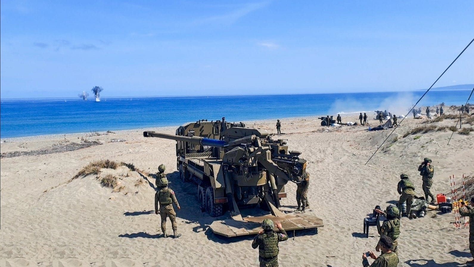 The howitzer platoon of the 3rd Self-Propelled Battery, 10th Field Artillery Battalion (10FAB) utilizing the ATMOS 2000 self-propelled gun fires at an off-shore target during the Counter-Landing live fire drill at the Sand Dunes, La Paz, Laoag City, Ilocos Norte on May 6, 2024.?