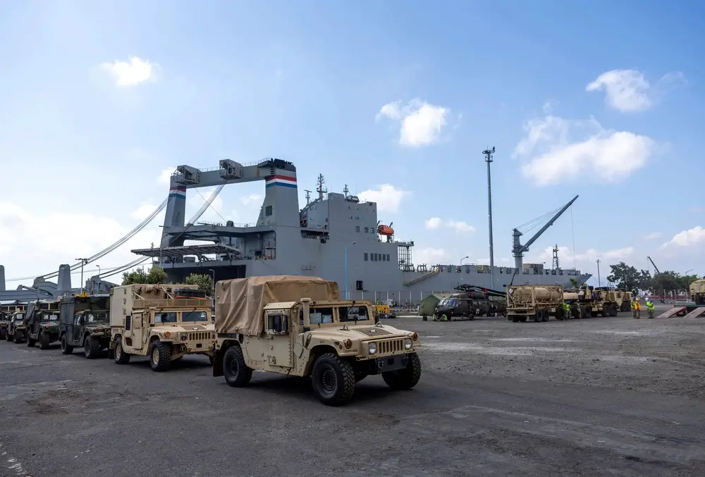 Military vehicles are staged near Military Sealift Command chartered ship MV Cape Hudson (T-AKR 5066) during an offload of equipment in support of exercise Super Garuda Shield 2024, at the Port of Banyuwangi, Indonesia Aug. 12. (Photo by Grady T. Fontana/ U.S. Navy)