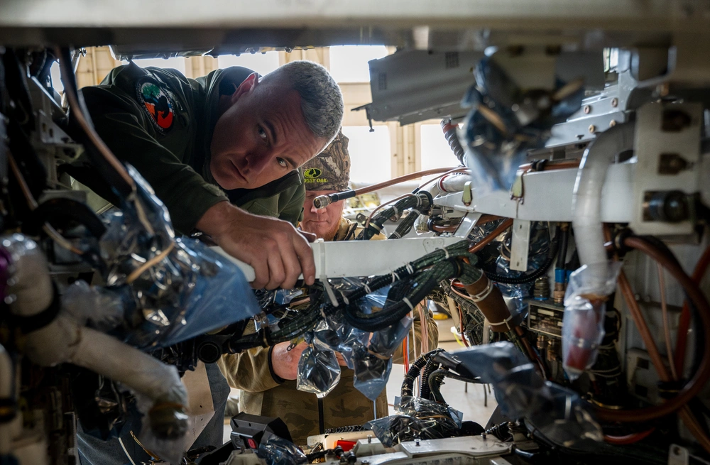 Chris Kiser, an aviation engineer, works on modifying an F-16 Fighting Falcon’s wiring as part of Viper Experimentation and Next-gen Operations Model – Autonomy Flying Testbed program at Eglin Air Force Base, Florida. The changes include software, hardware and instrumentation that will allow the aircraft to fly autonomously. (U.S. Air Force photo by Samuel King Jr.)