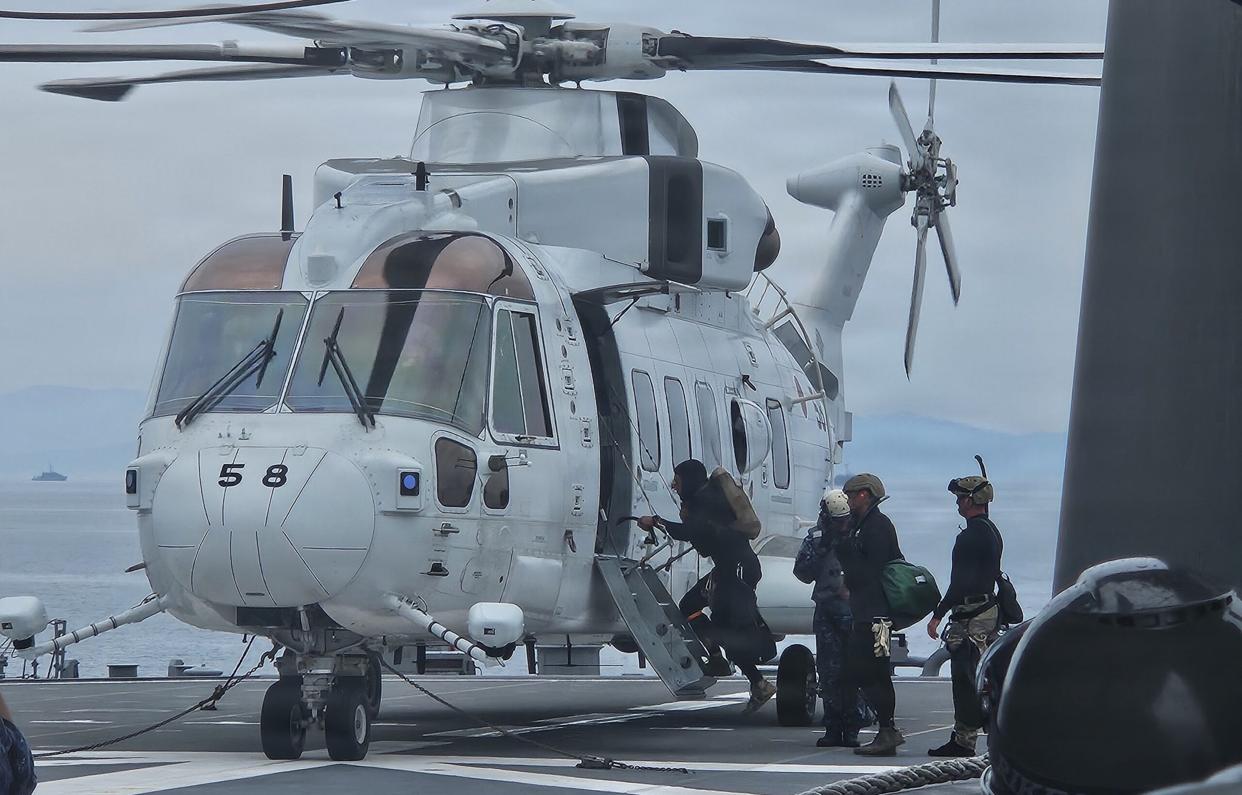 U.S. Navy Explosive Ordnance Disposal Mobile Unit 5 and Japan Maritime Self-Defense Force explosive ordnance disposal sailors board a JMSDF MCH-101 helicopter during mine countermeasure diving operations as part of Mine Warfare Exercise (MINEX) 2JA, July 14, 2026. (U.S. Navy photo by Lt. Jacob Kinnear)