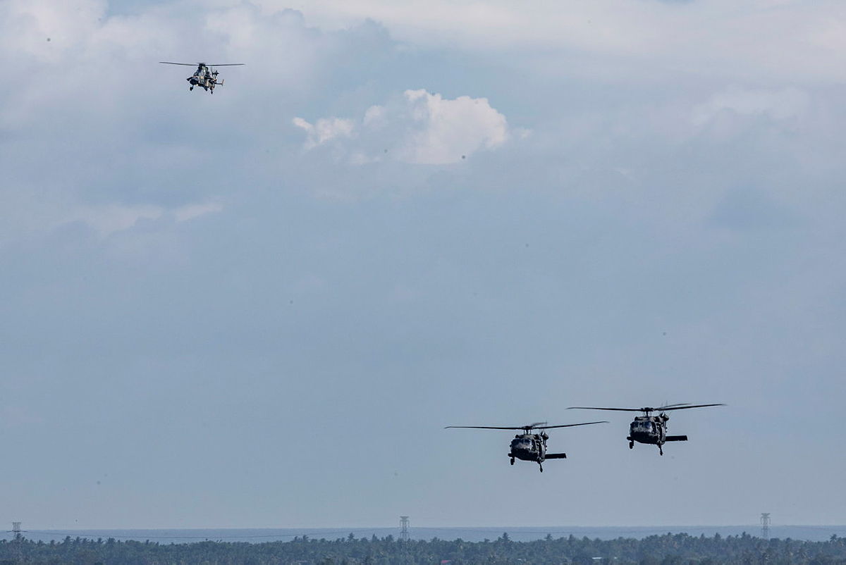 An Australian Army Tiger Armed Reconnaissance helicopter escorts two United States Army UH-60M Black Hawks during a mission as part of Exercise Keris Strike 26 in Sabah, Malaysia.