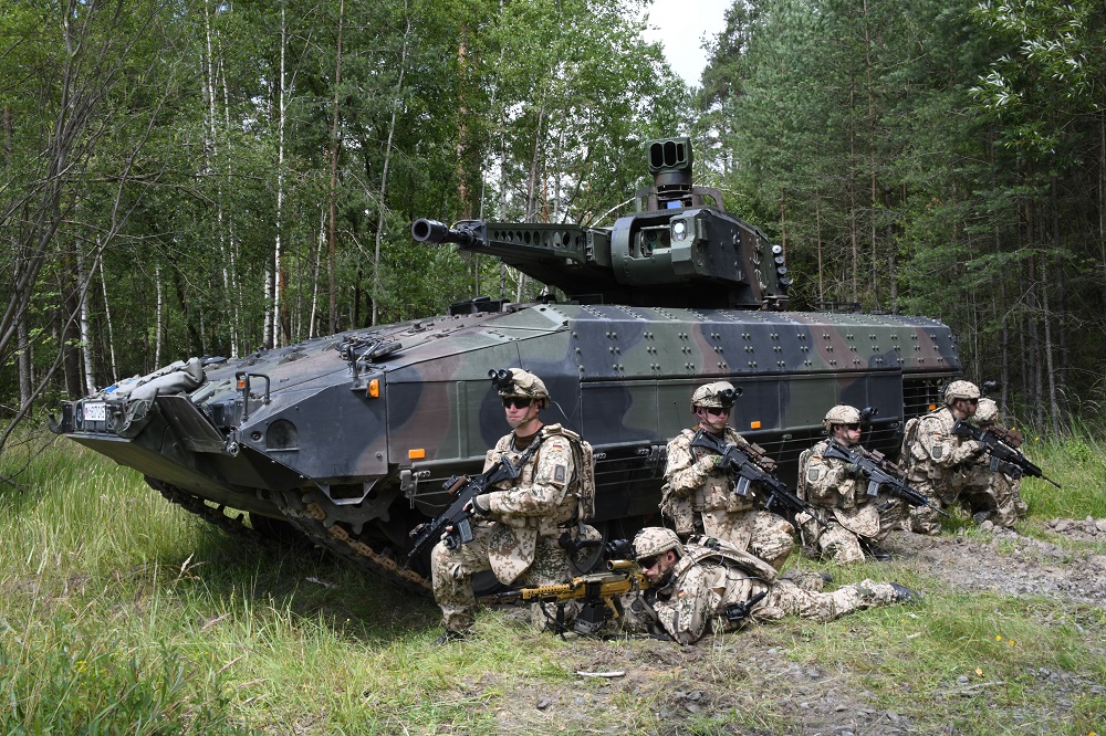 Two PUMA infantry fighting vehicles at full speed on the training grounds in Munster. (Photo by KMW)