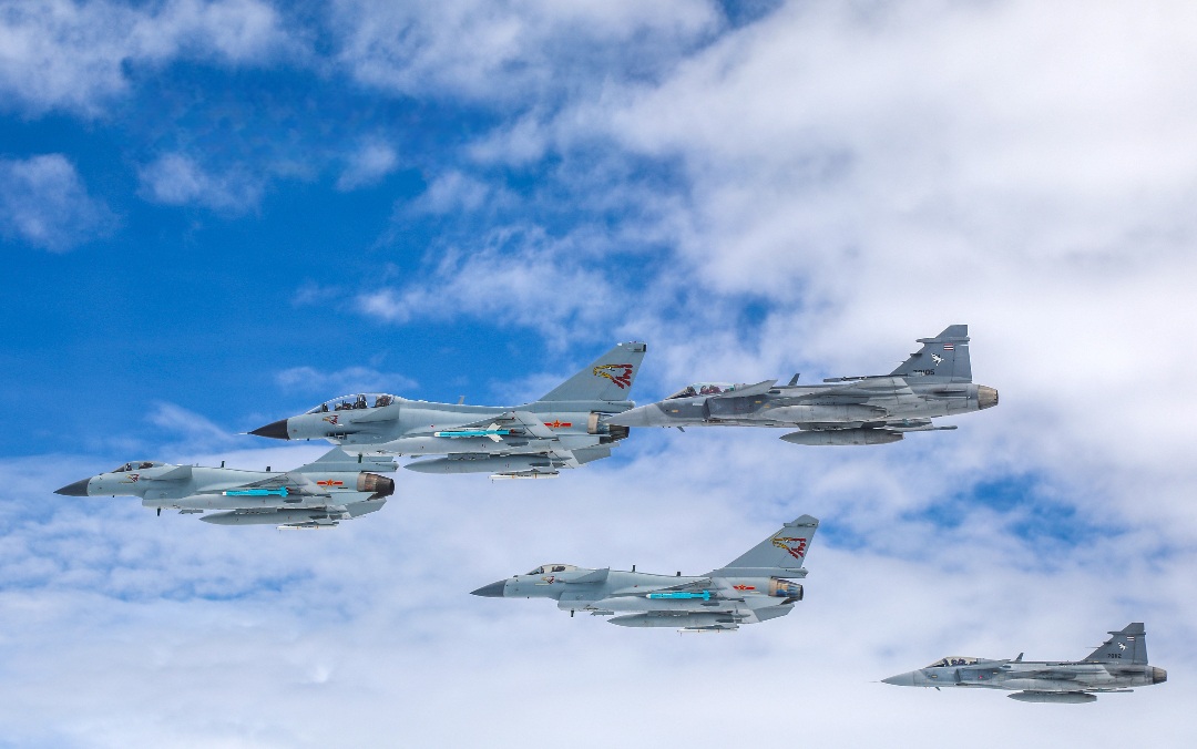 Fighter jets from China's PLA Air Force and the Royal Thai Air Force fly in tactical formation during a joint training exercise. The closing ceremony of the joint exercise code-named